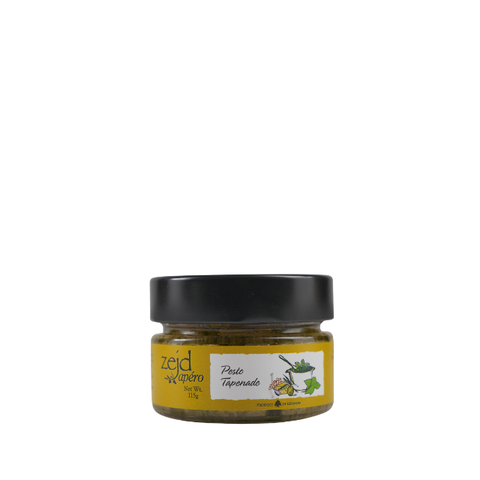 A small glass jar of Zeid Al-Rifaa Pasta Aromada, featuring a black lid and a yellow label with a white central section and green illustrations, set against a plain white background.